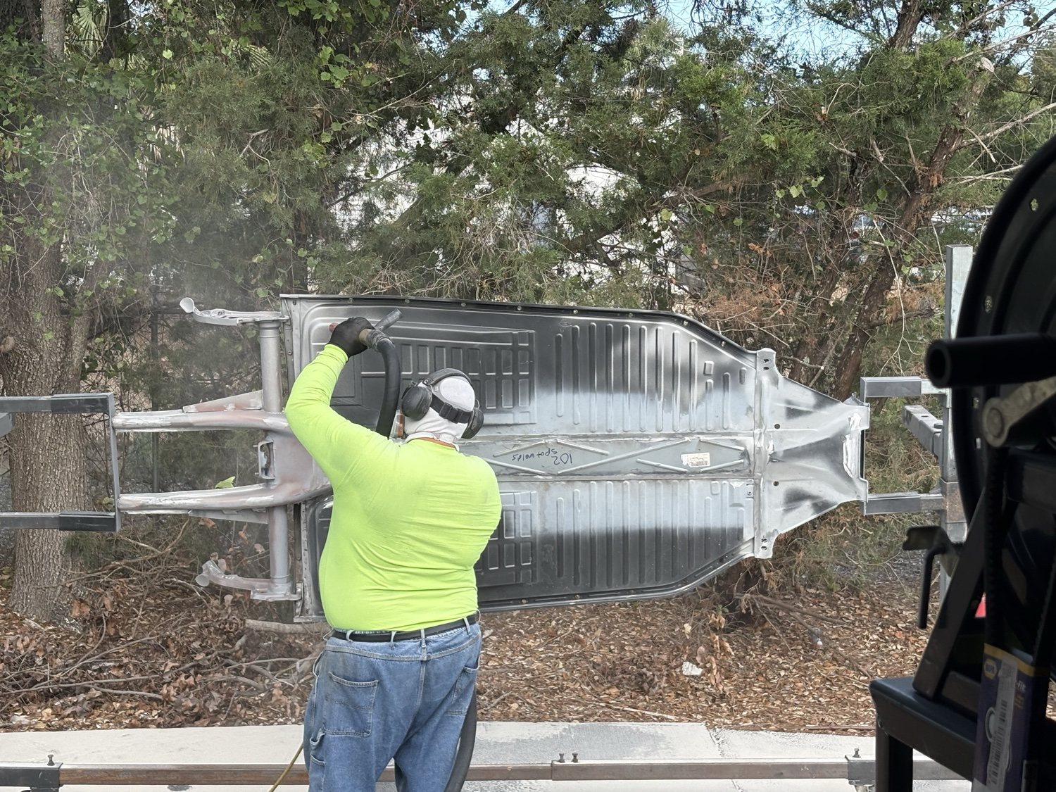 SWFL Media Blasters operator media-blasting an aluminum boat hull on-site