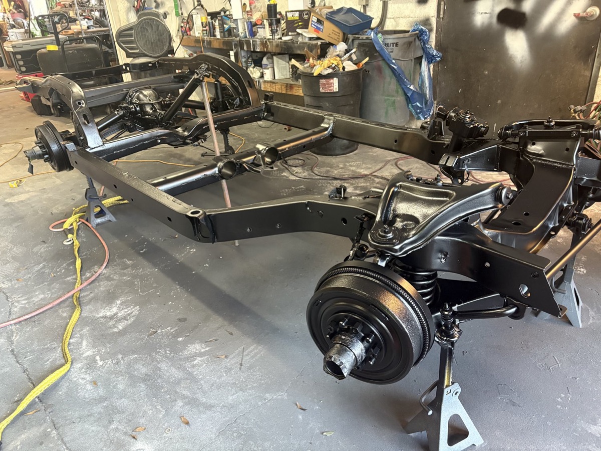Classic car fender media-blasted to bare metal in a restoration garage