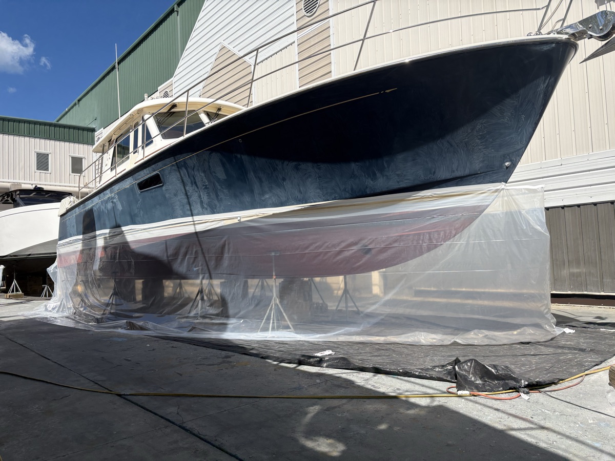 Sport-fish boat hull masked and blasted in a Naples boatyard